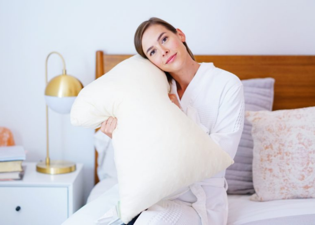woman holding an organic pillow