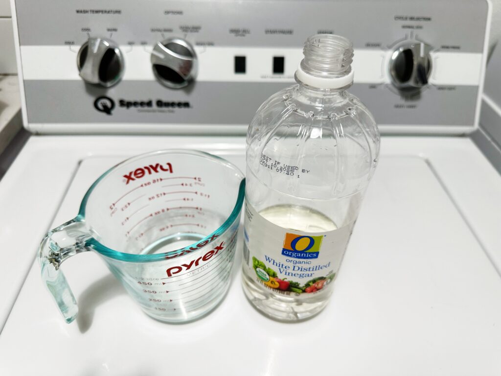 organic vinegar bottle and glass measuring cup