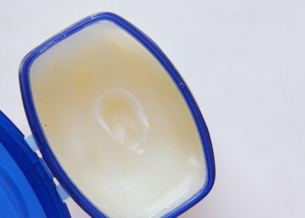 Closeup of petroleum jelly in a blue container