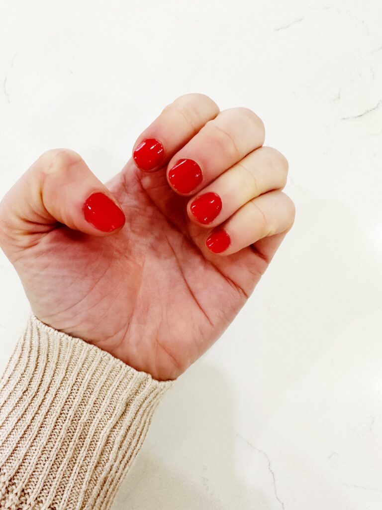 woman's nails wearing Manicurist in Poppy Red